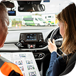 Instructor_and_woman_sit_in_a_car-talking_about_driving_instructions_ISM_Driving_Lessons