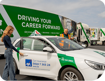 A_woman_stands_beside_a_car_with_driving_instructor_ISM_Driving_lessons