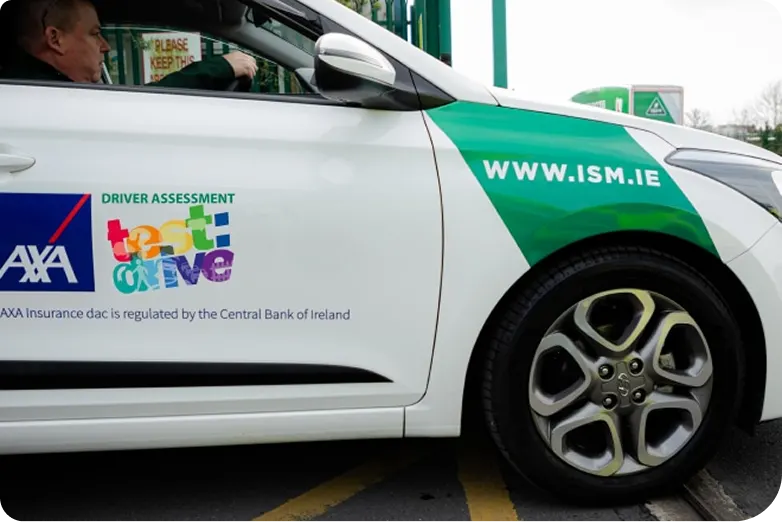 A_car_in_white_and_green_colors_with_ISM_logo_ISM_Driving_Lessons