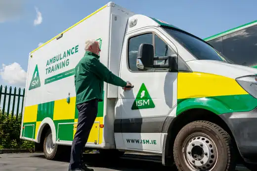 An_ambulance_is_parked_outside_a_building _ISM Training_and_Recruitment