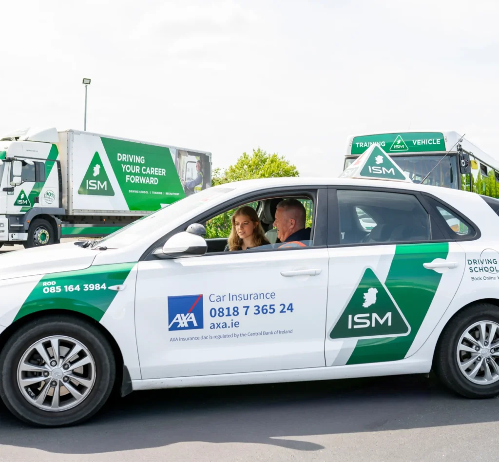 Woman_sitting_in_the_car_with_driving_instructor_ISM_Driving_lessons