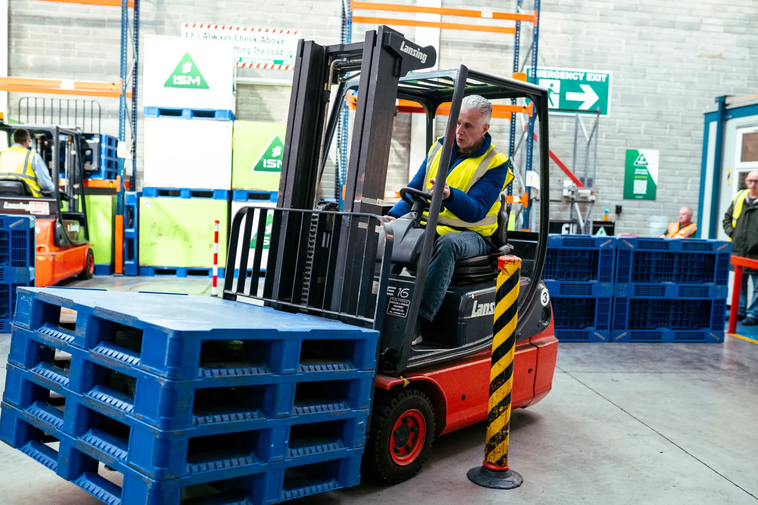 A_man_operates_a_forklift_inside_a_warehouse_ISM_Driving_lessons
