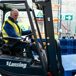 A_man_in_a_safety_vest_drives_a_forklift_ISM_Driving_lessons