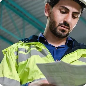 Man_in_a_safety_vest_examines_a_document_ISM_Driving_Lessons