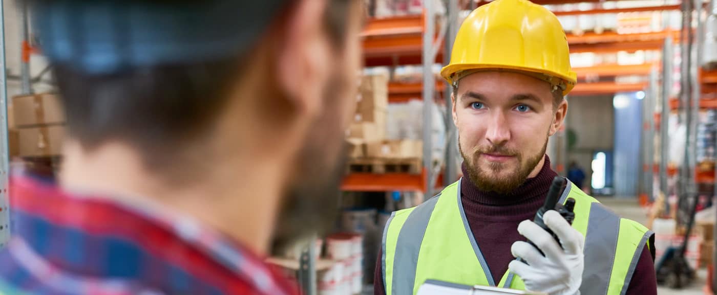 A_man_wearing_a_hard_hat_is_speaking_on_a_cell_phone _ISM_Training_and_Recruitment