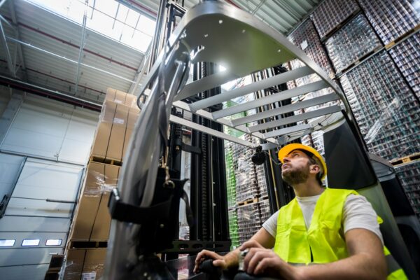 man_wearing_a_safety_vest_operates_a_forklift-ISM