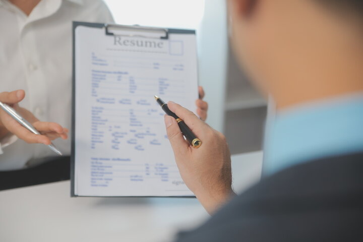 A_man_is_focused_on_writing_a_resume _ISM_Training_and_Recruitment
