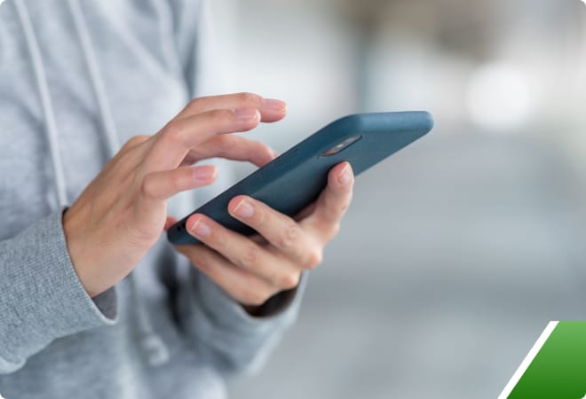 A_man_holding_a_mobile_phone _ISM Training_and_Recruitment
