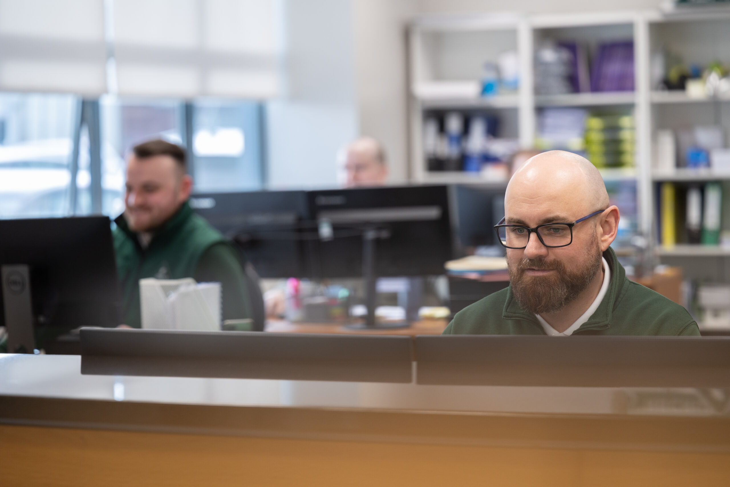 man_sits_at_a_desk_focused_on_his_work-ISM