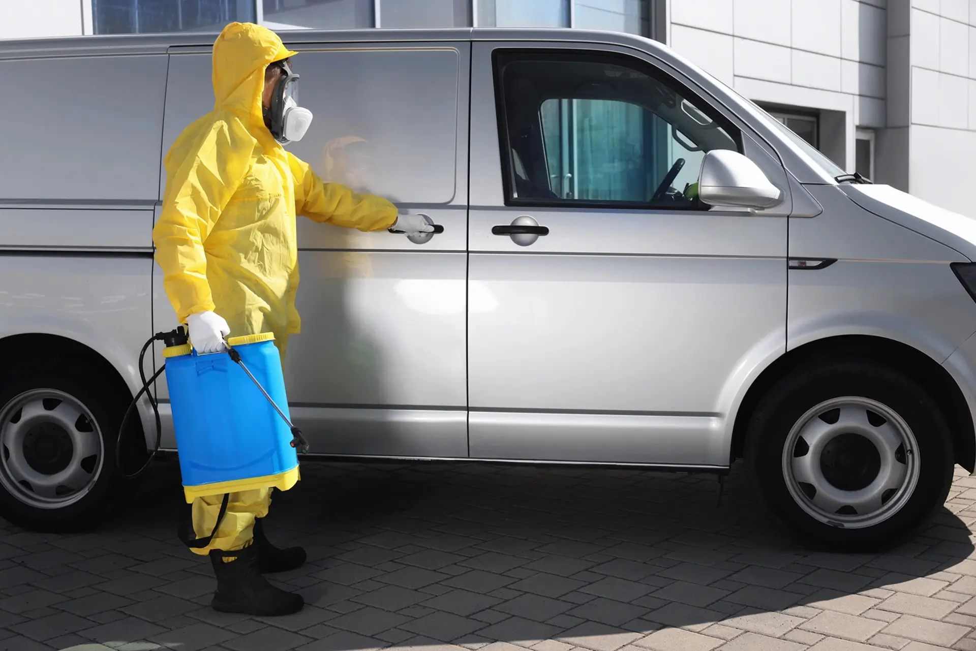 man_wearing_safety_equipment_stands_next_to_a_van-ISM